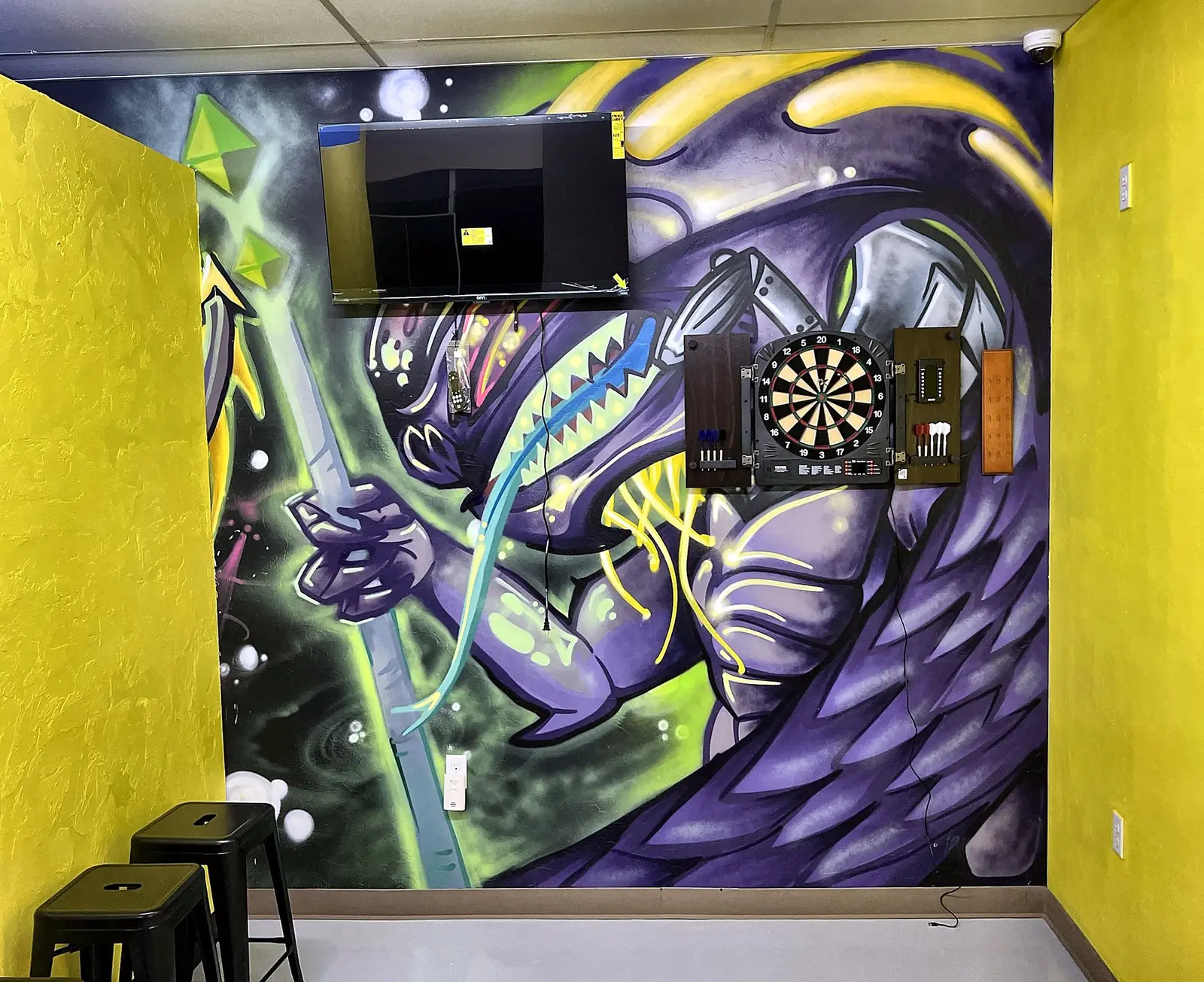 Dart board on a purple graffiti wall