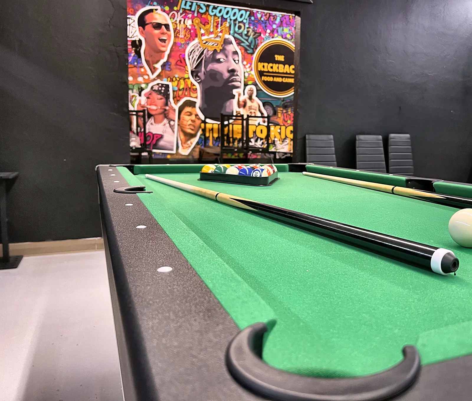 Pool table in front of the Kickback mural